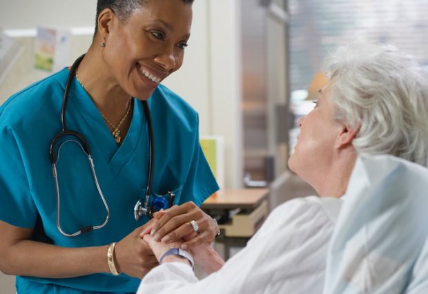 Nurse holding a patient's hand